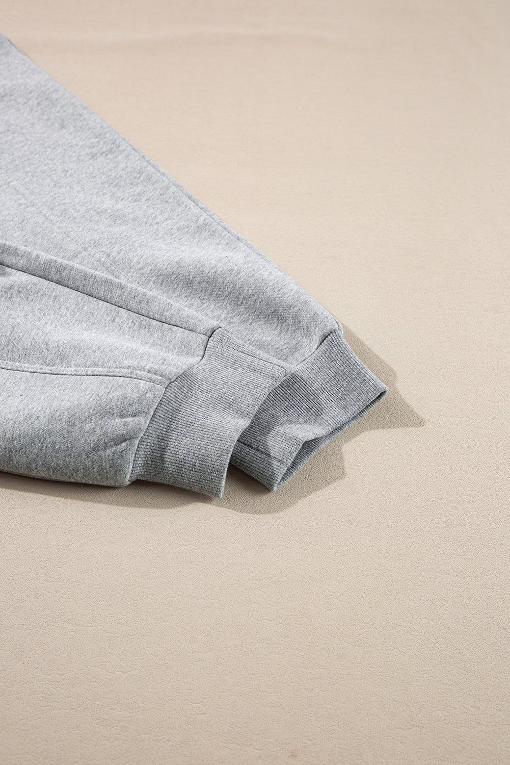 Gray fabric folded on a beige surface