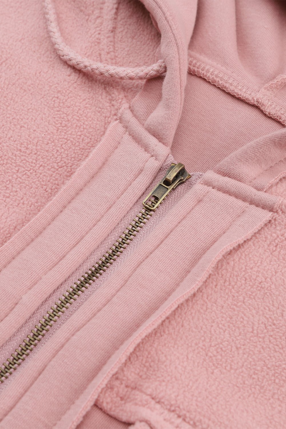 Close-up of a pink fleece jacket with a zipper