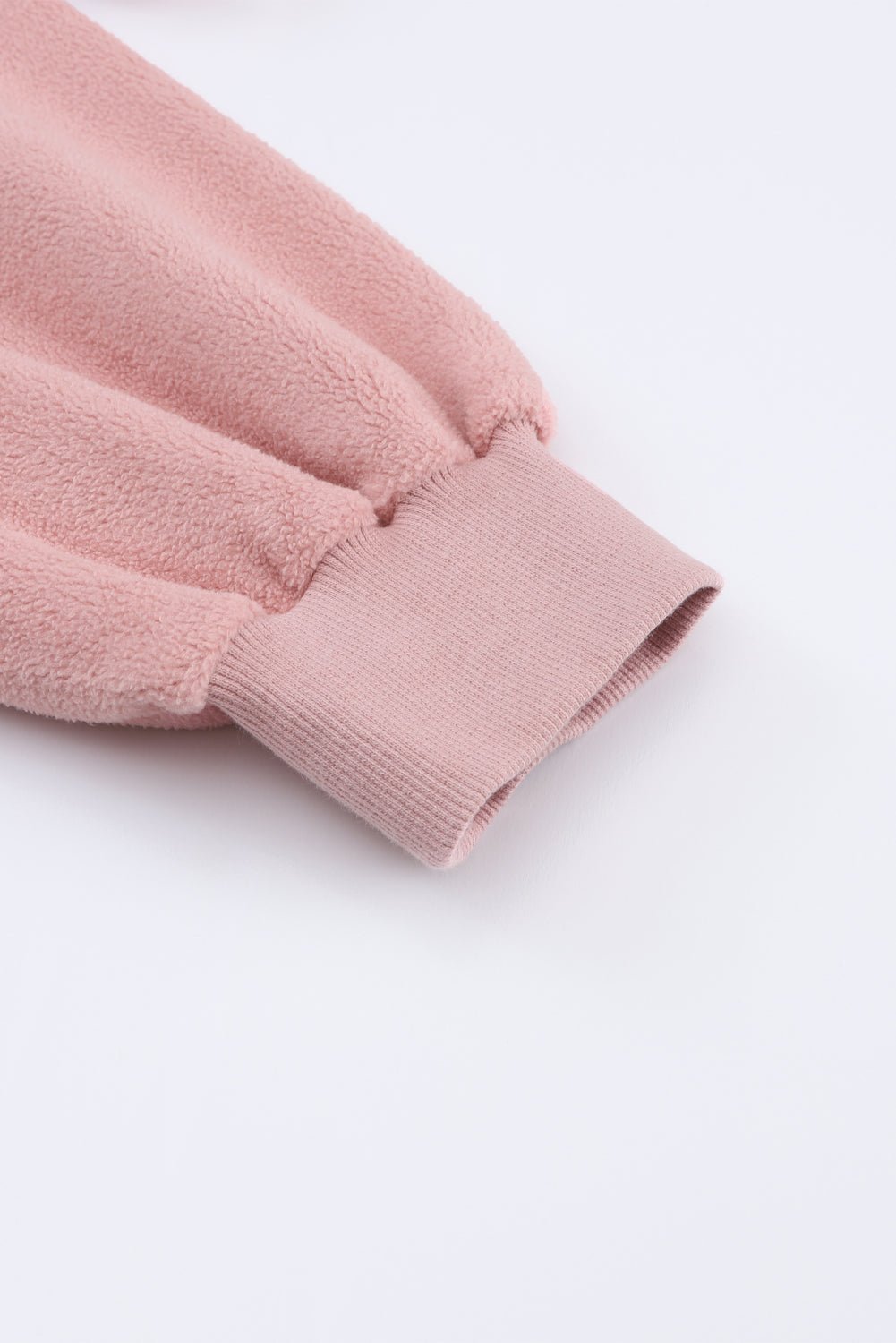 Close-up of a pink textured fabric on a white background