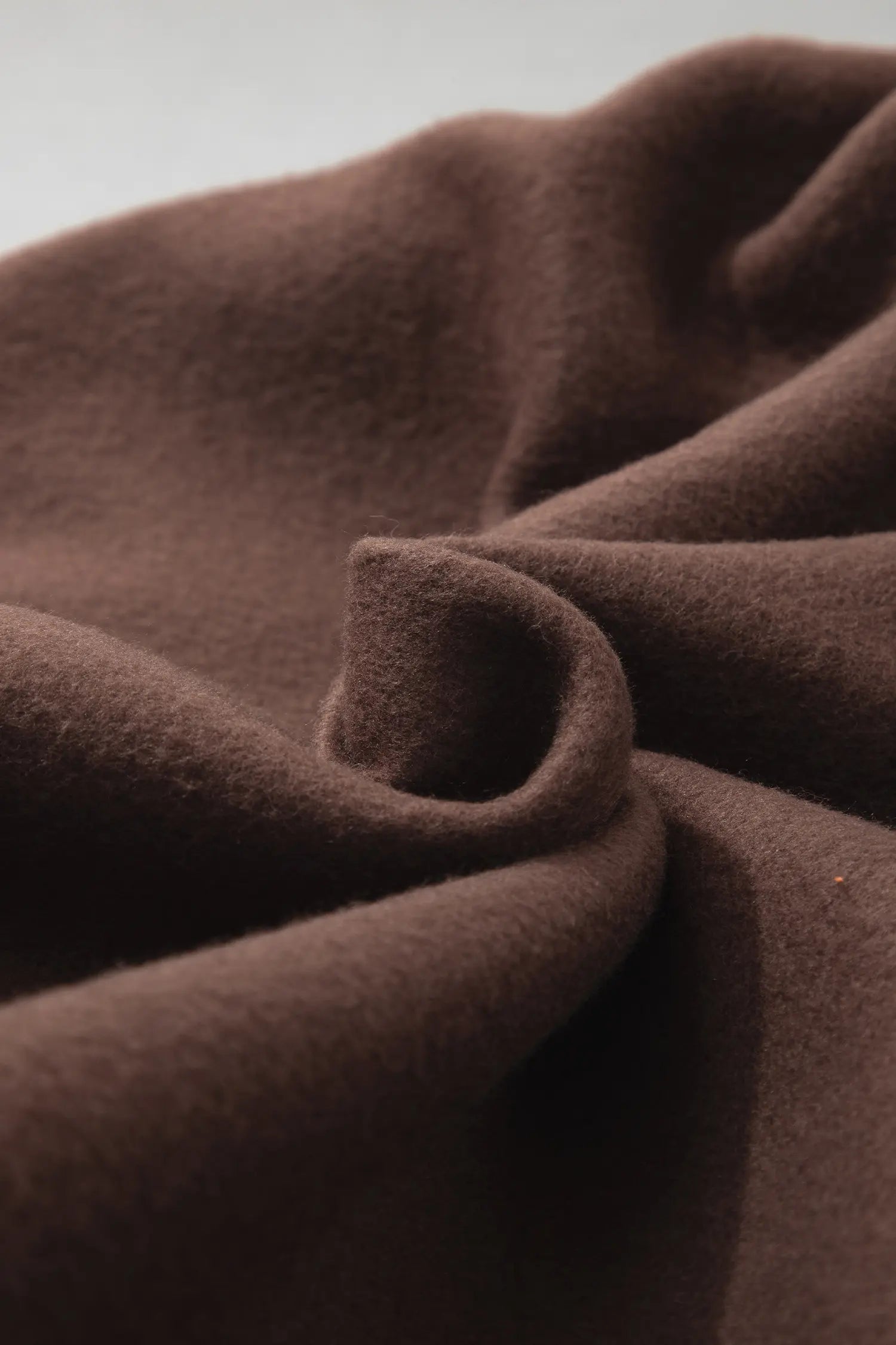 Folded coffee brown fleece showing soft texture