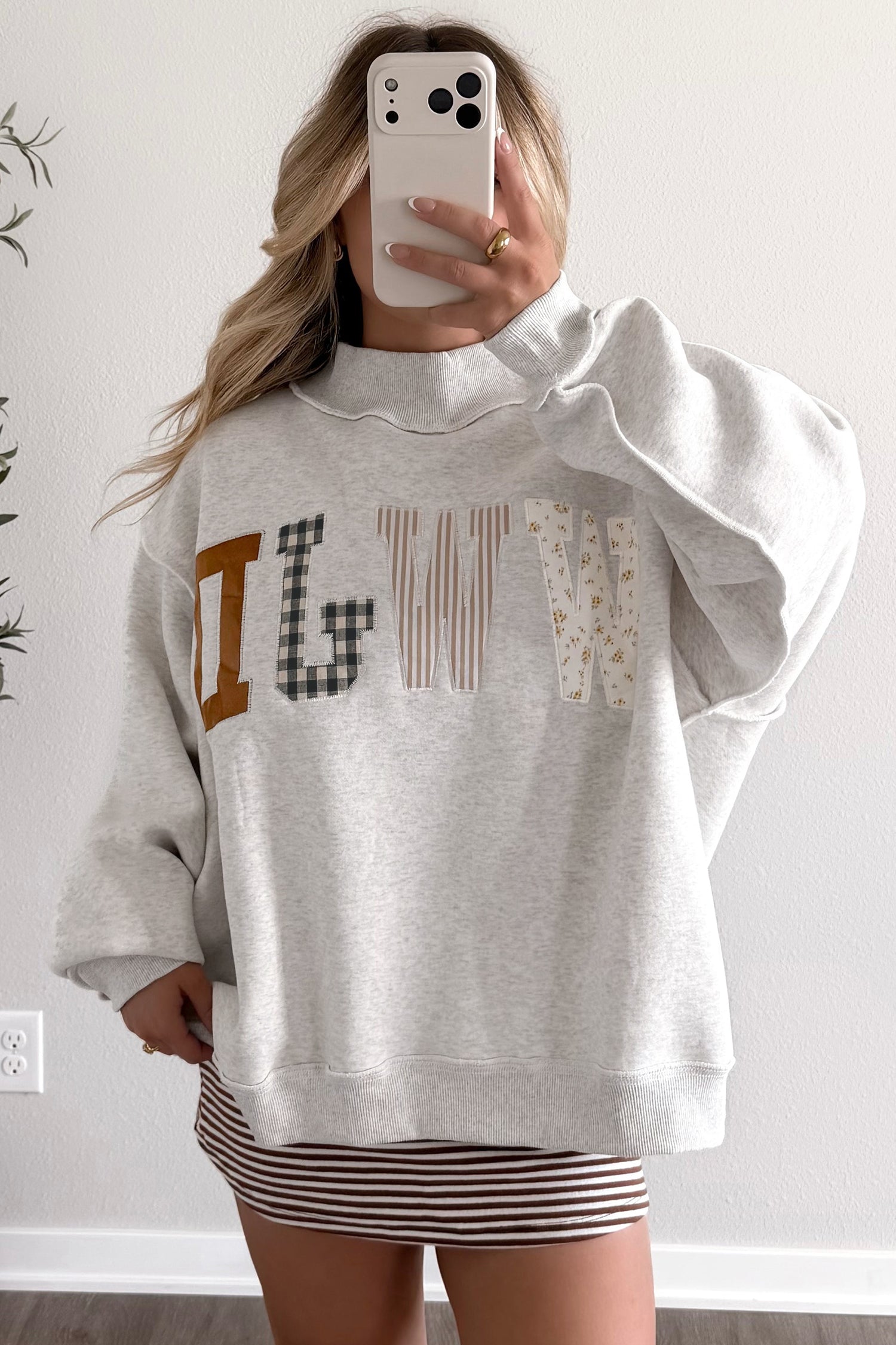 Mirror selfie in gray WWJD patchwork letter mock neck sweatshirt