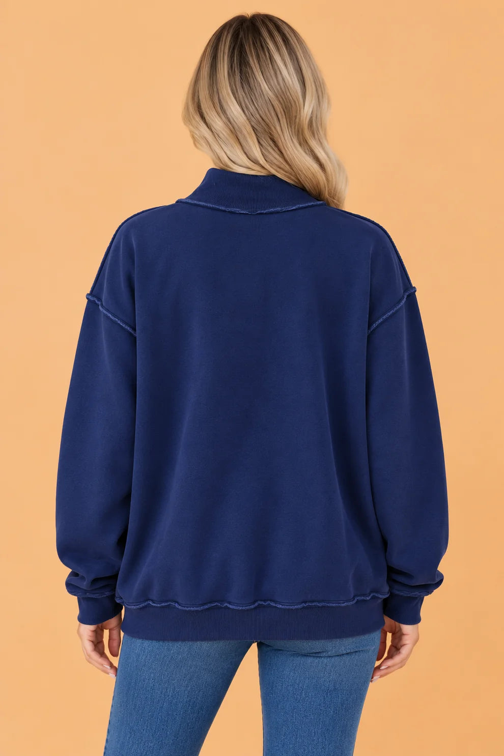 Back view of navy oversized mock neck sweatshirt with ribbed hem