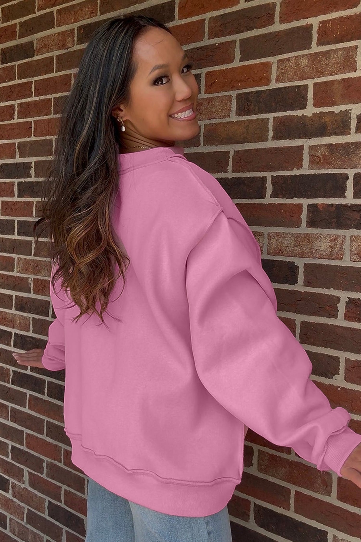 Back view of bonbon pink oversized mock neck sweatshirt