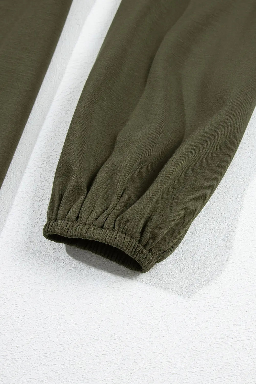 Elastic balloon sleeve cuff on jungle green dress