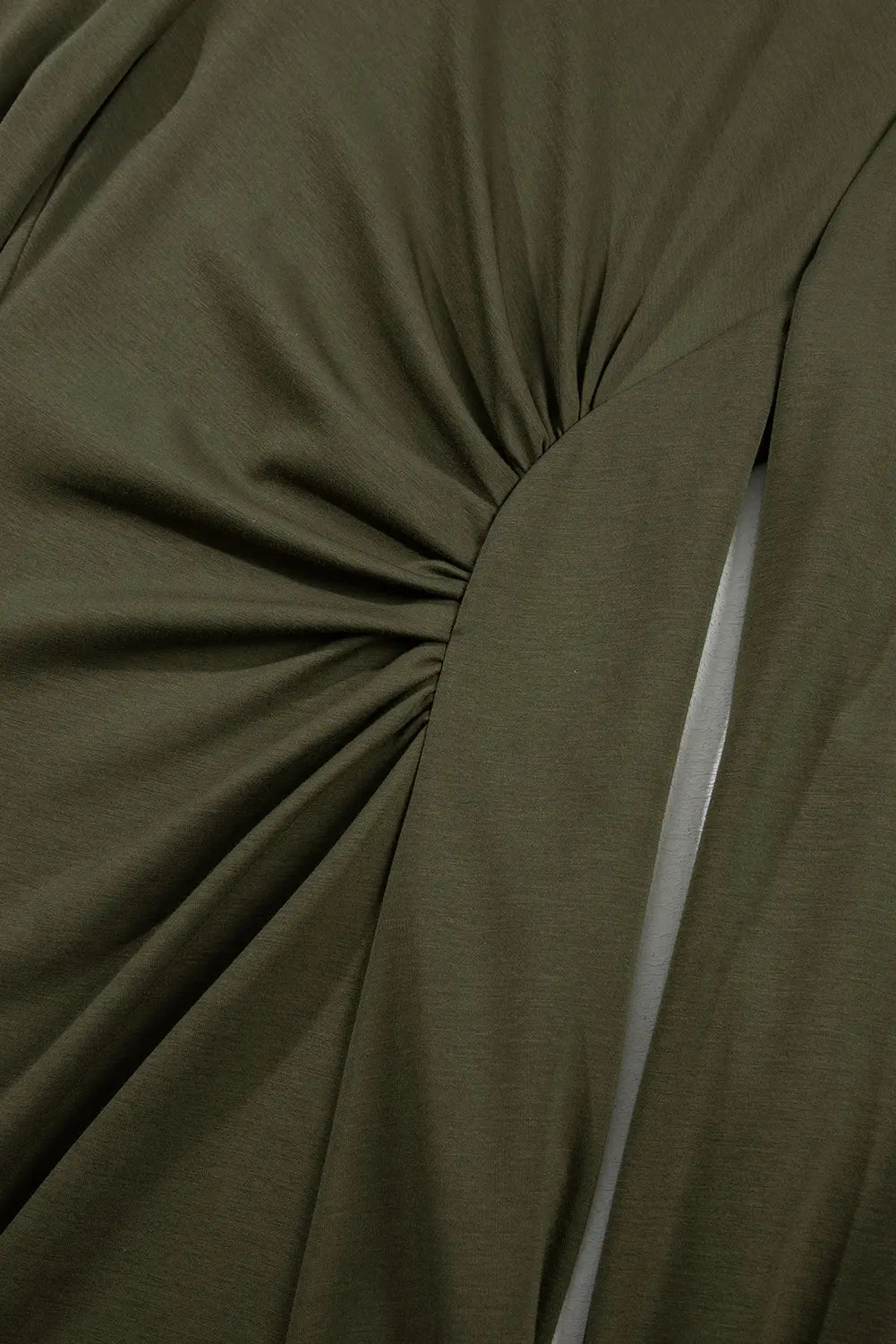 Close-up of gathered ruched waist detail on jungle green midi dress