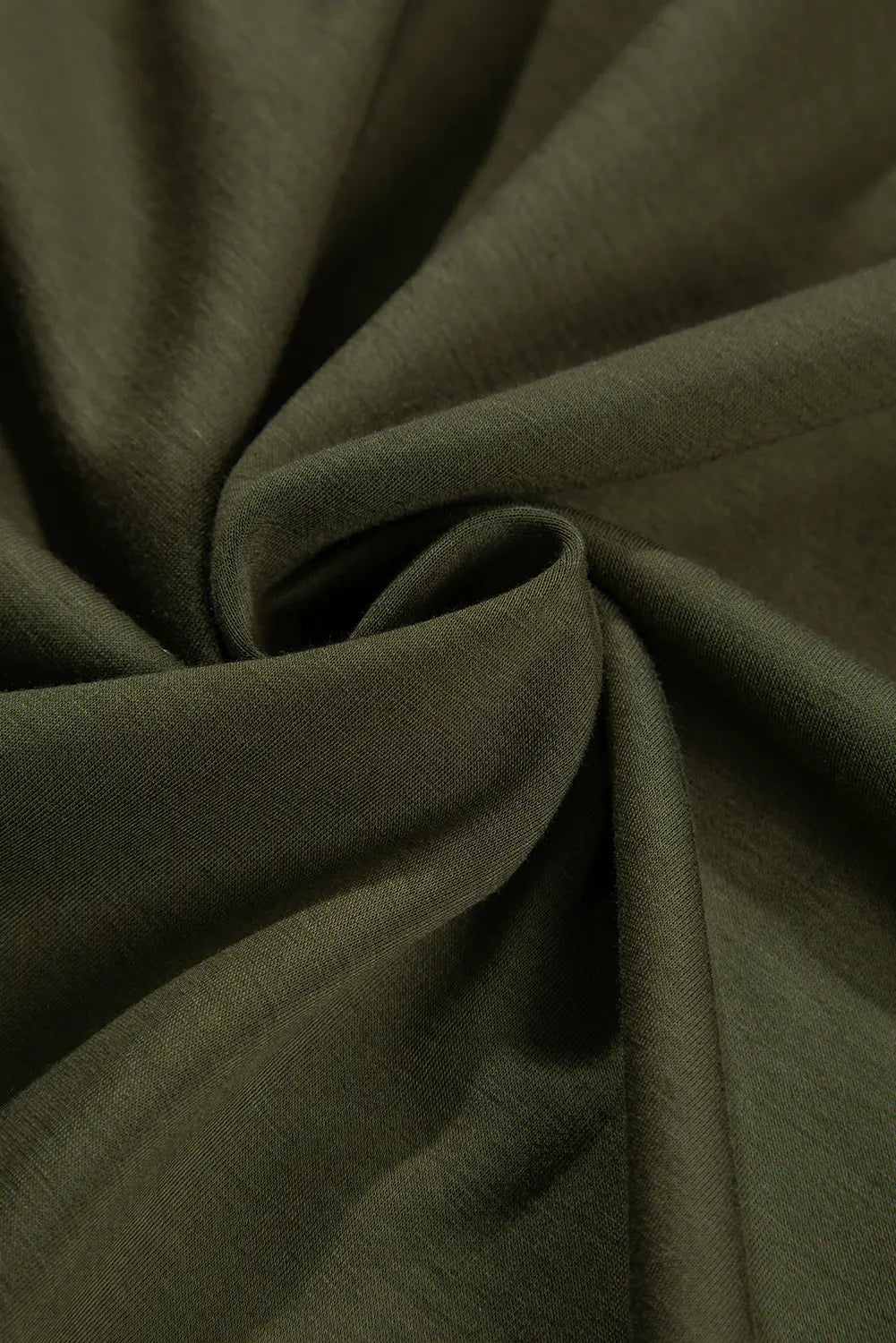 Swirled jungle green jersey fabric showing soft drape