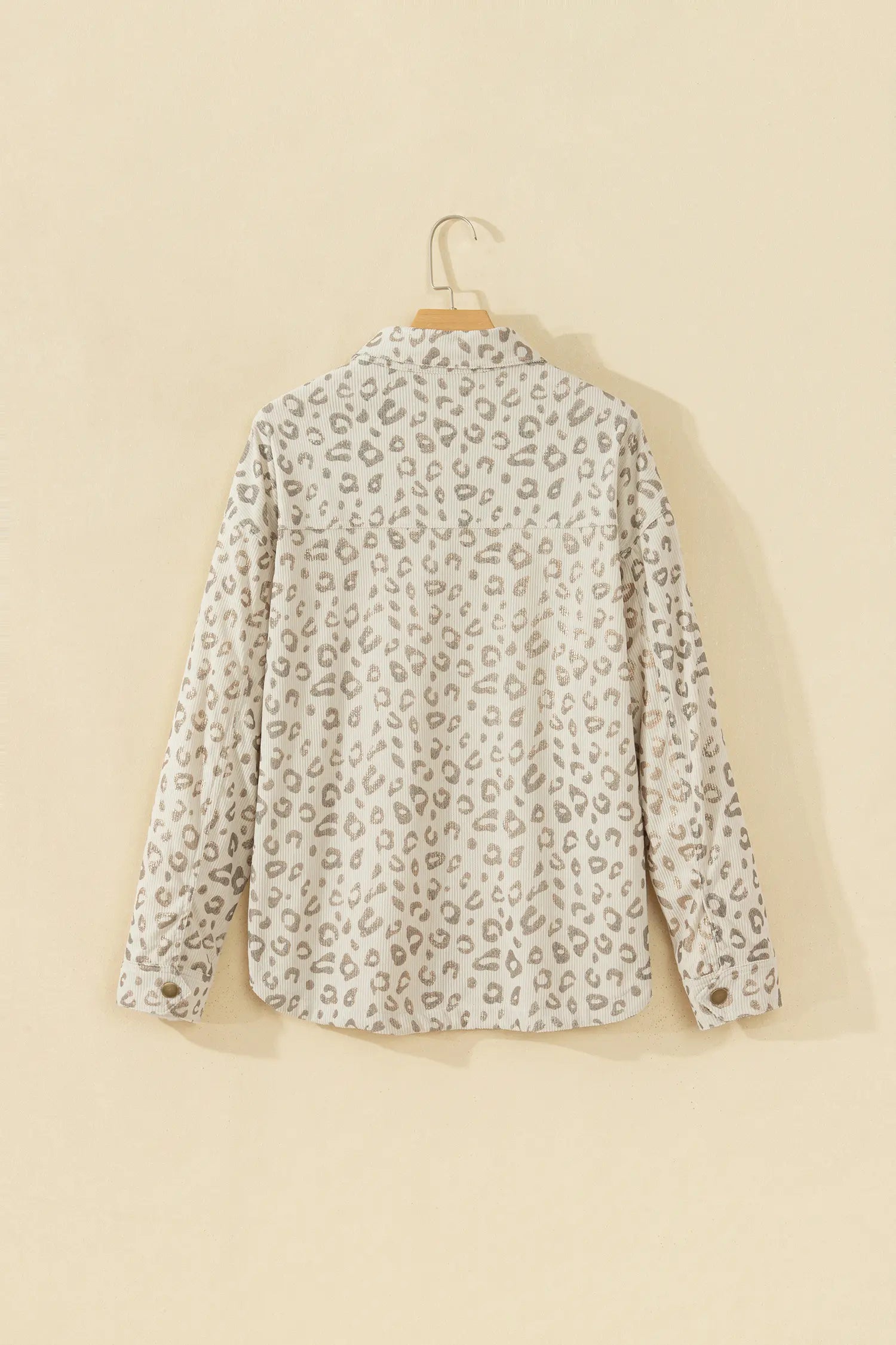 Khaki leopard corduroy shirt jacket on a hanger, back view