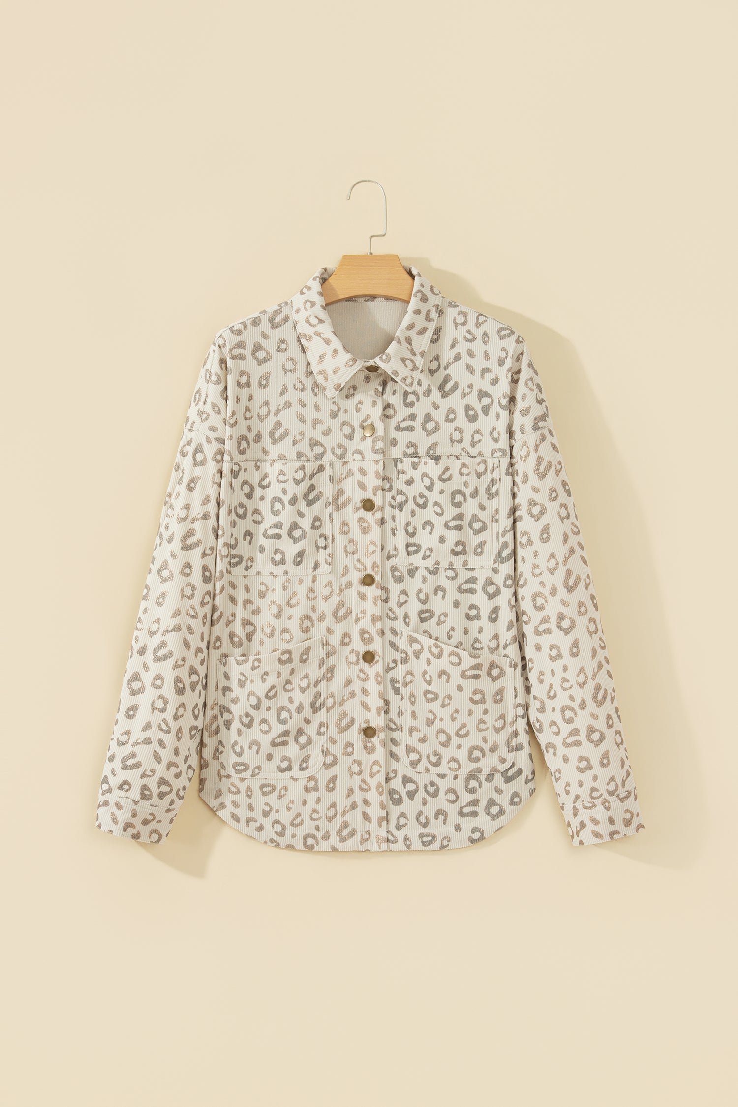 Khaki leopard corduroy shirt jacket on a hanger, front view