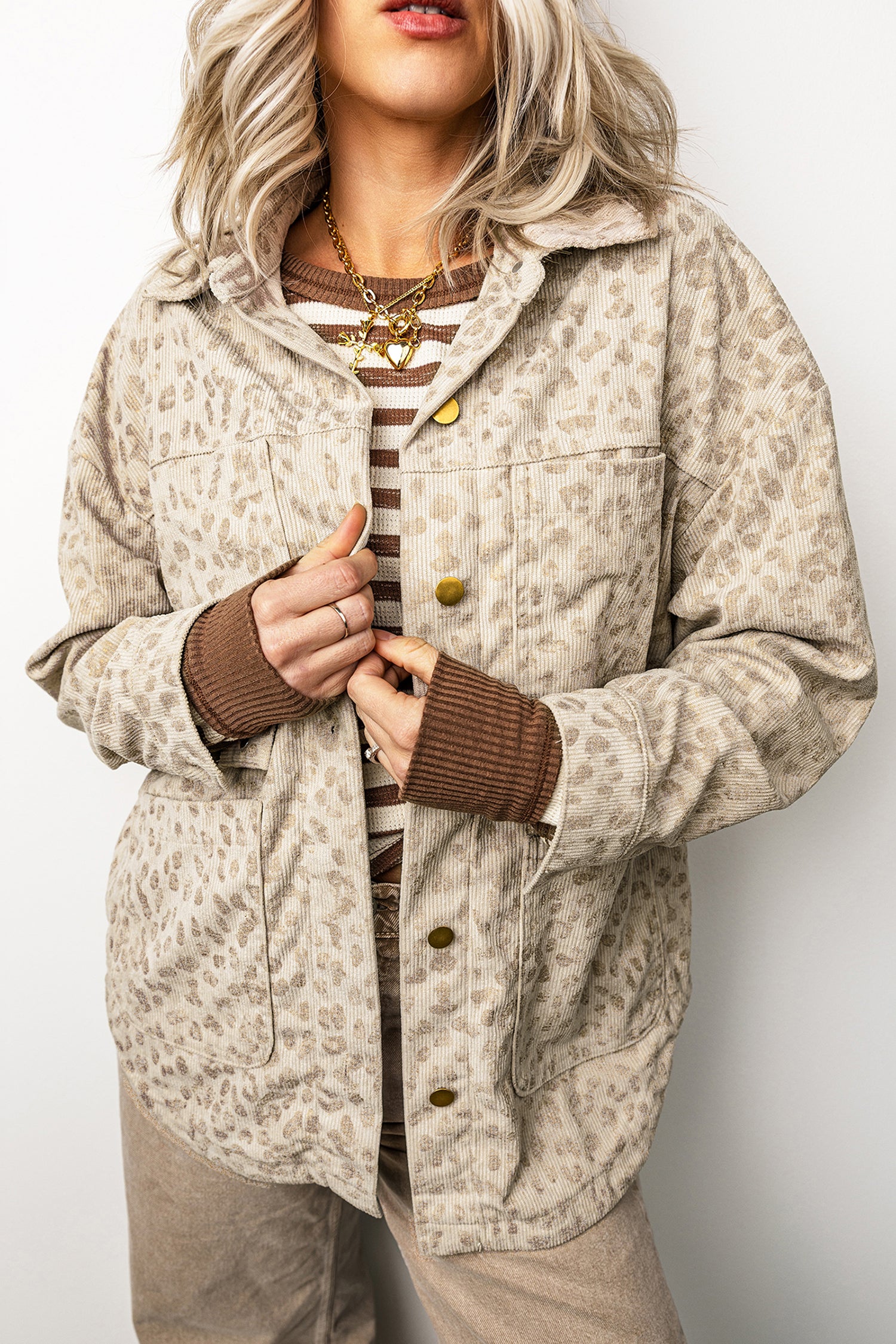 Khaki leopard corduroy jacket worn open with four patch pockets