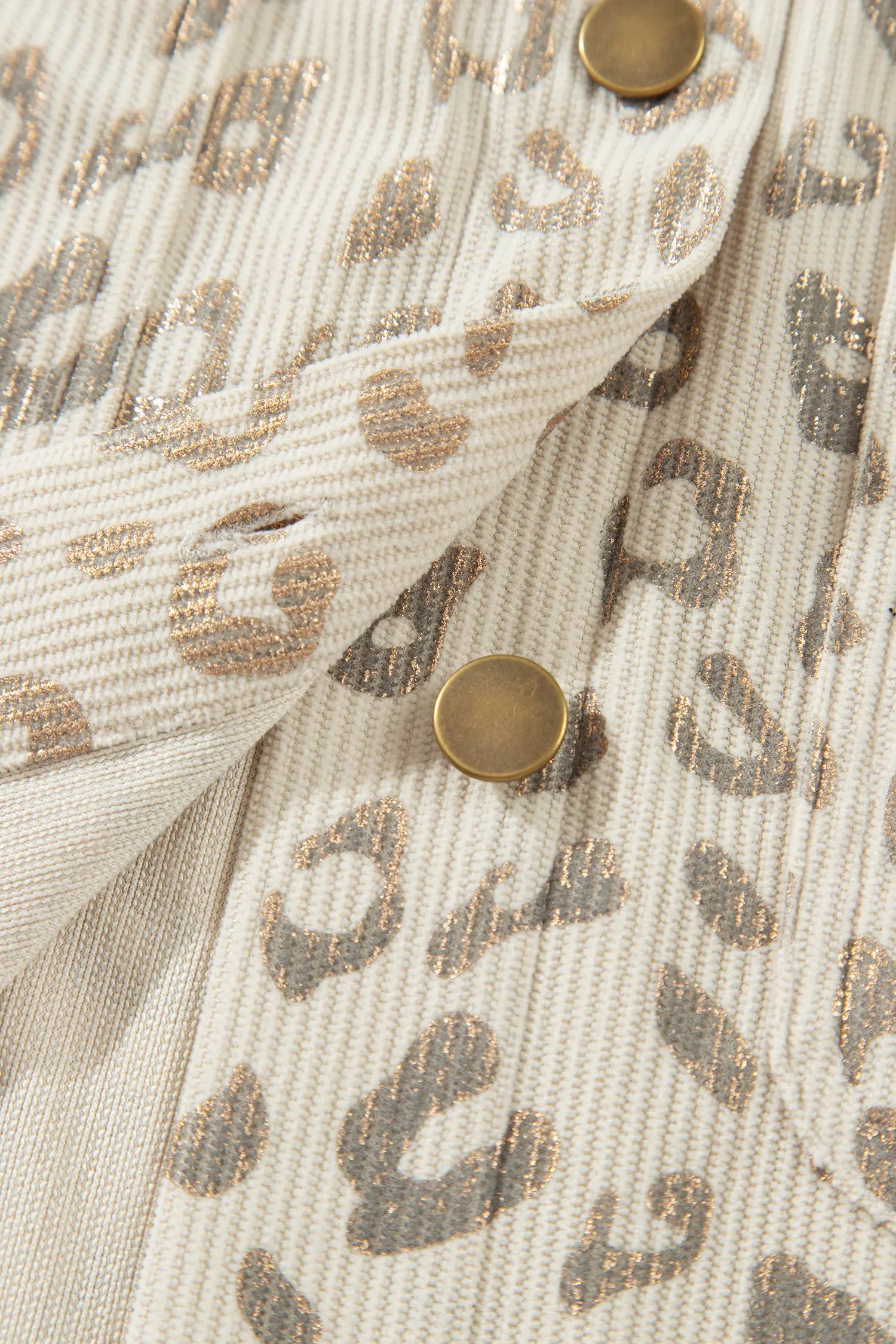 Snap placket on cream leopard corduroy with metallic shimmer
