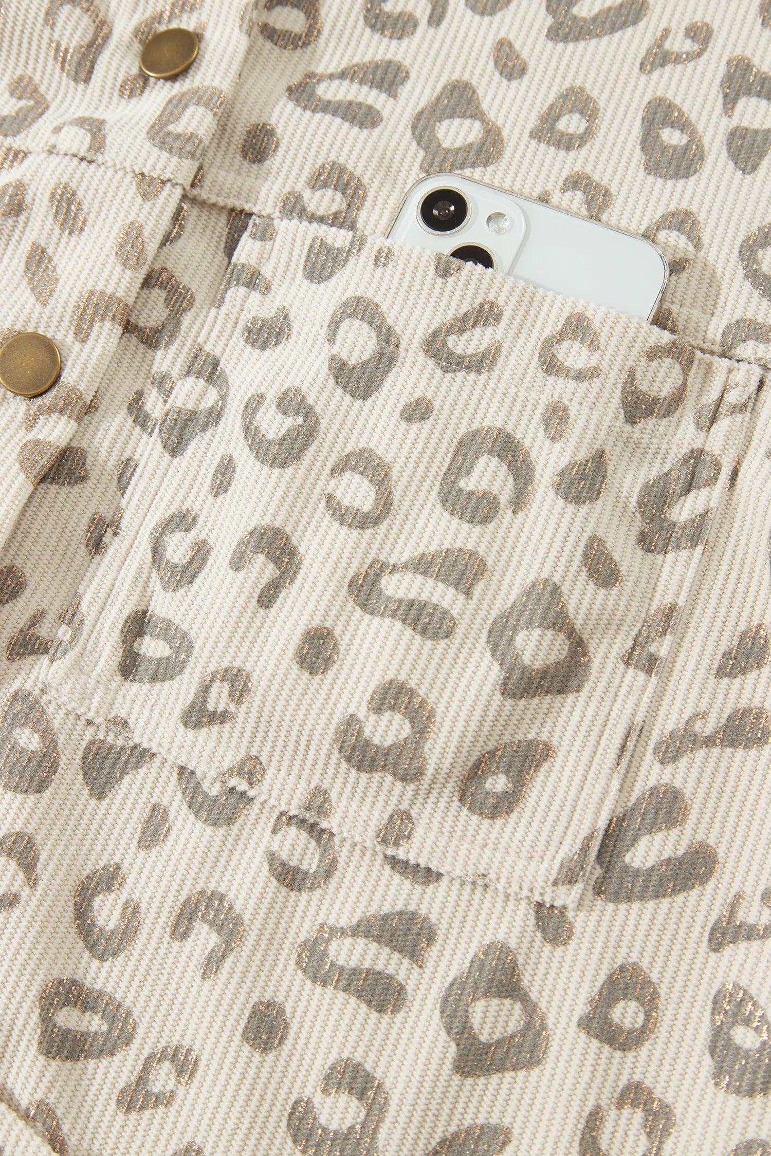Patch pocket holding a phone on khaki leopard corduroy jacket