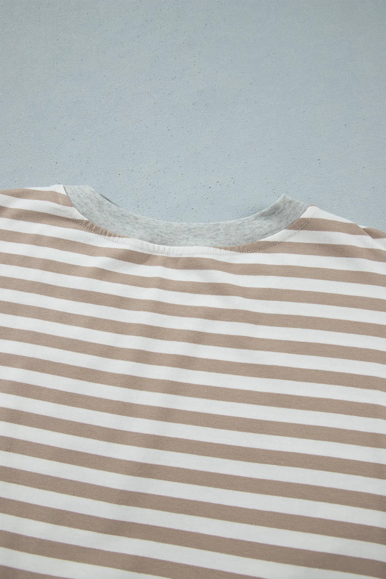 Back neckline with gray ribbed trim on khaki striped dress