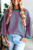 Woman wearing a striped shirt with long sleeves in a casual setting