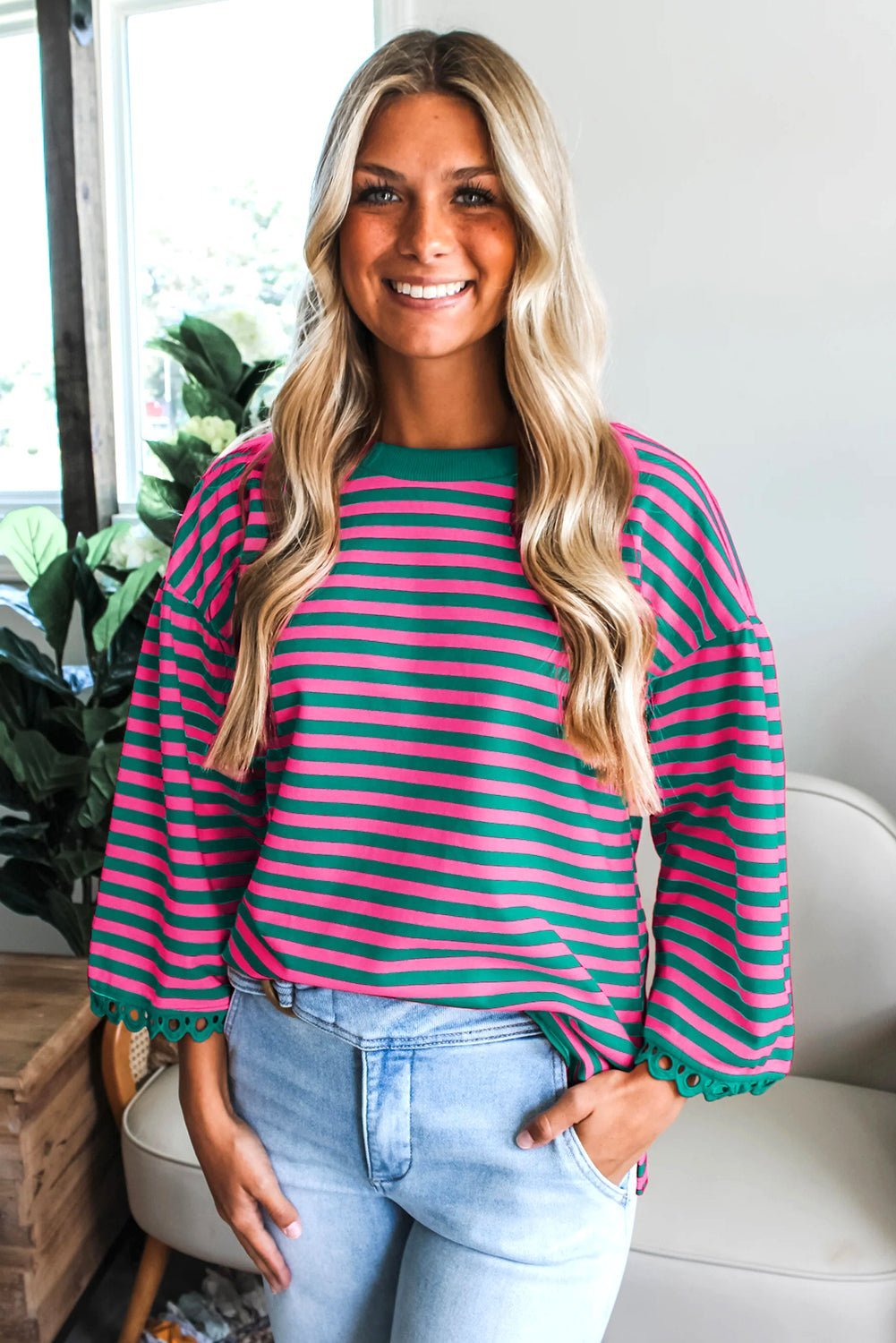 Woman wearing a striped sweater and jeans indoors