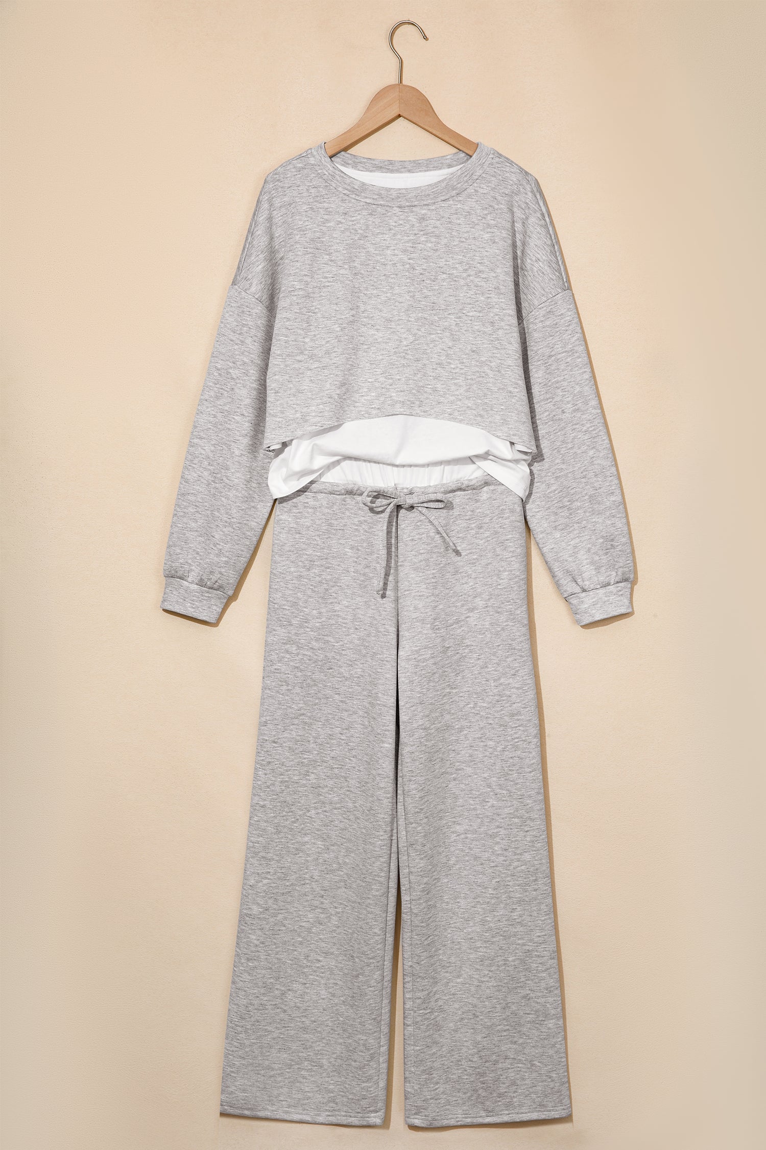 Gray crop top and drawstring wide leg pants set on a hanger, front view