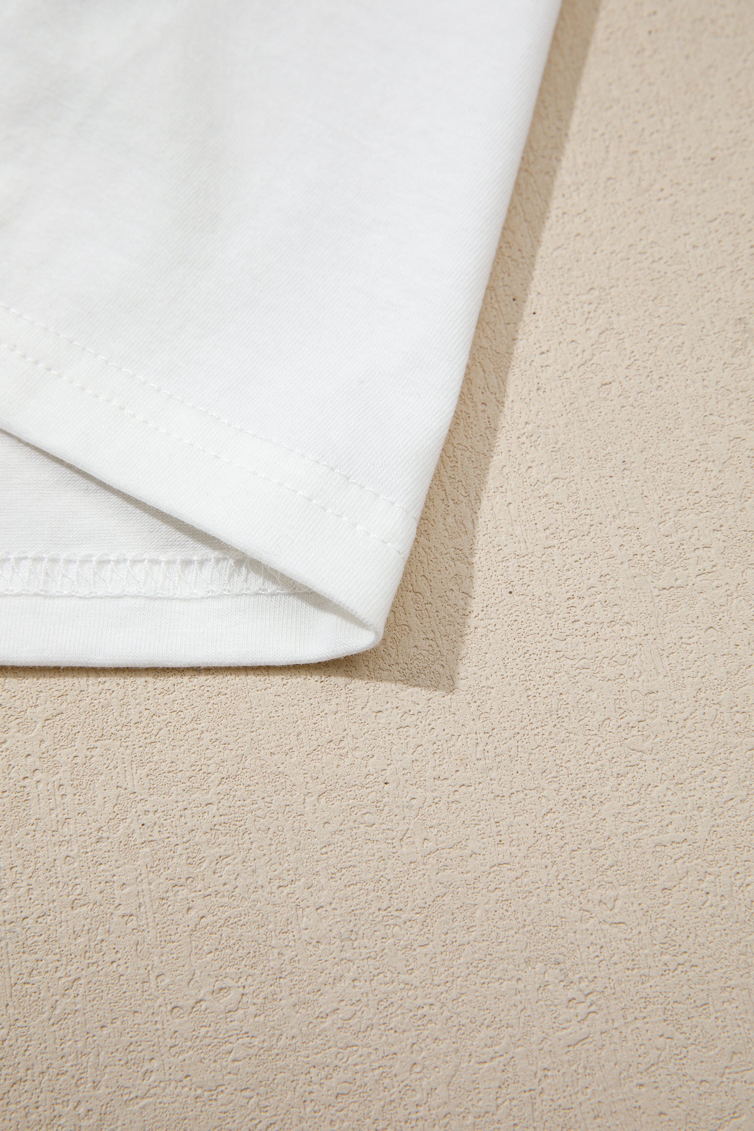 White contrast under-layer hem of the gray crop top