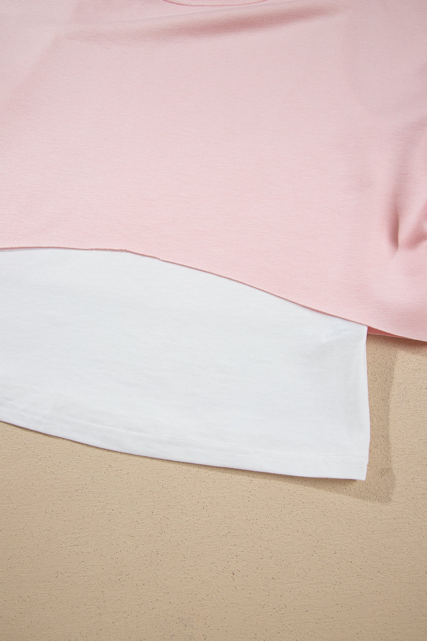 Pink crop top layered hem over white under-layer detail