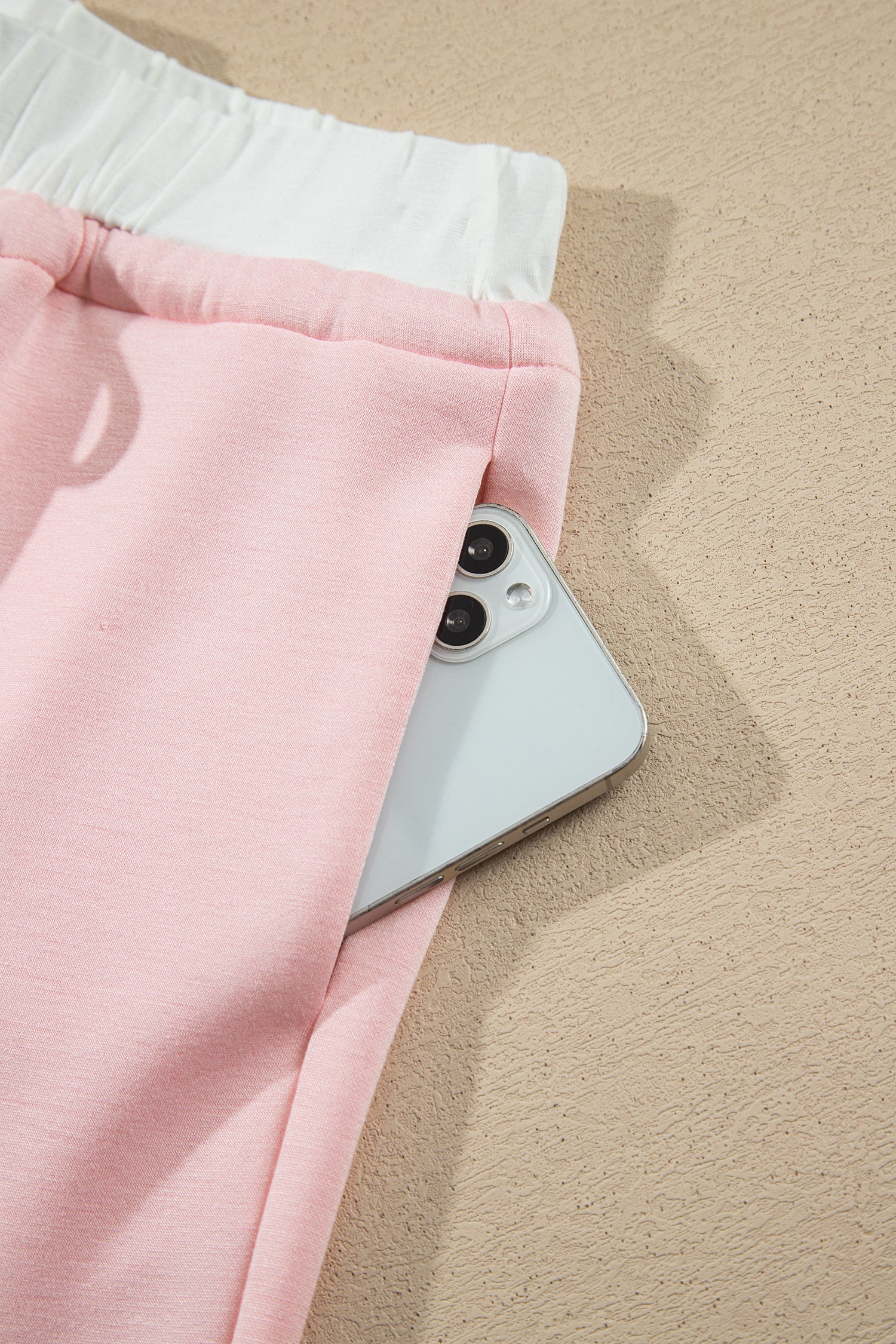 Pink wide leg pants side pocket holding a phone