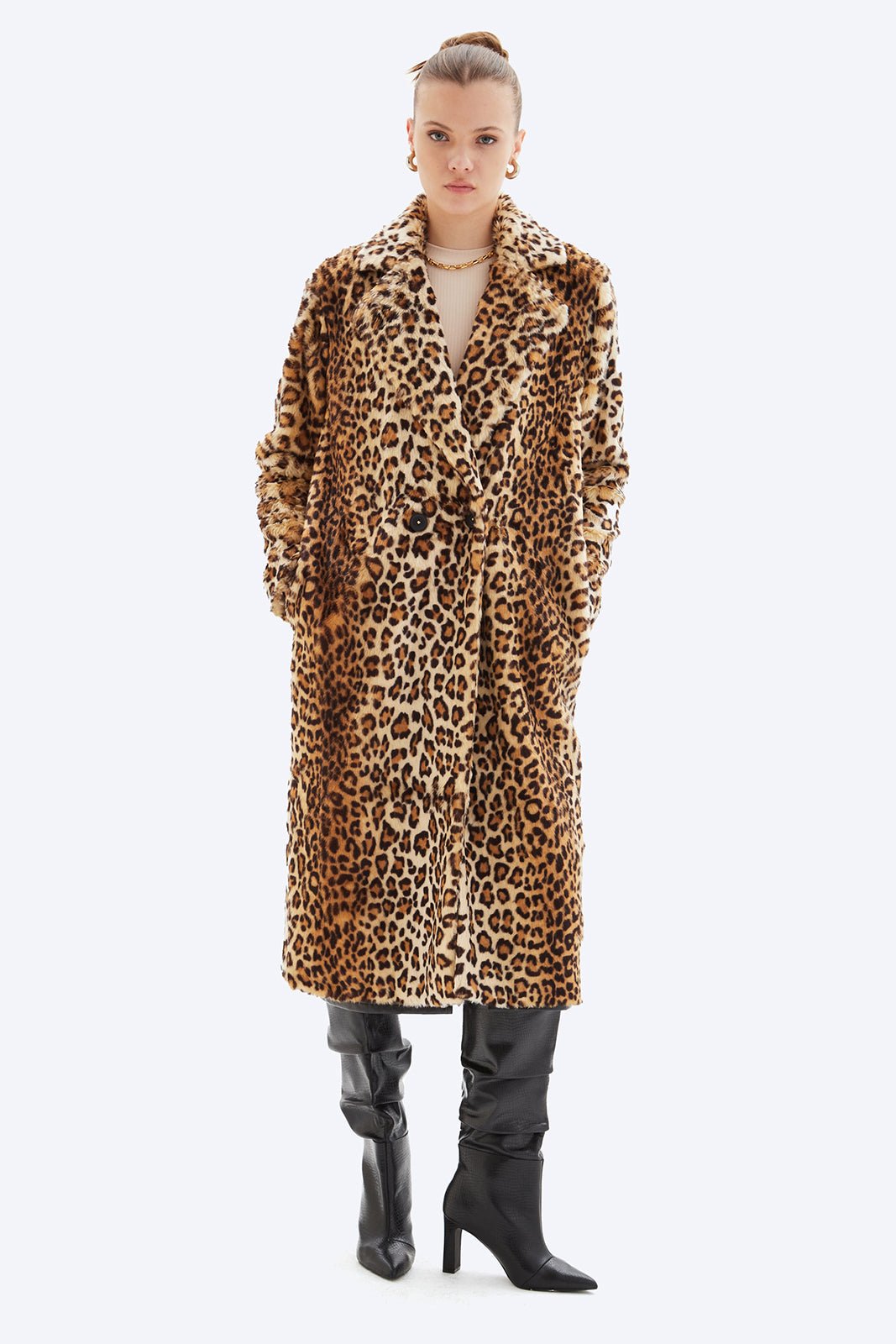 Person wearing a leopard print coat on a white background