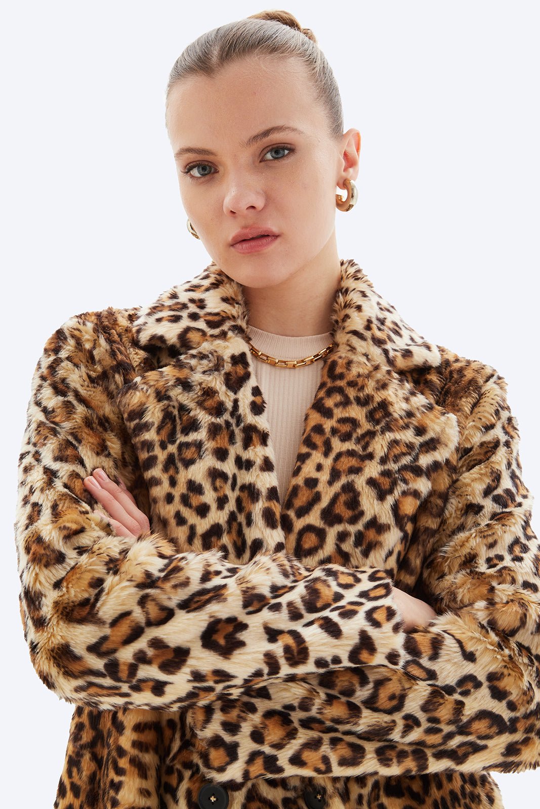 Person wearing a leopard print coat on a white background