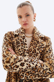 Person wearing a leopard print coat on a white background