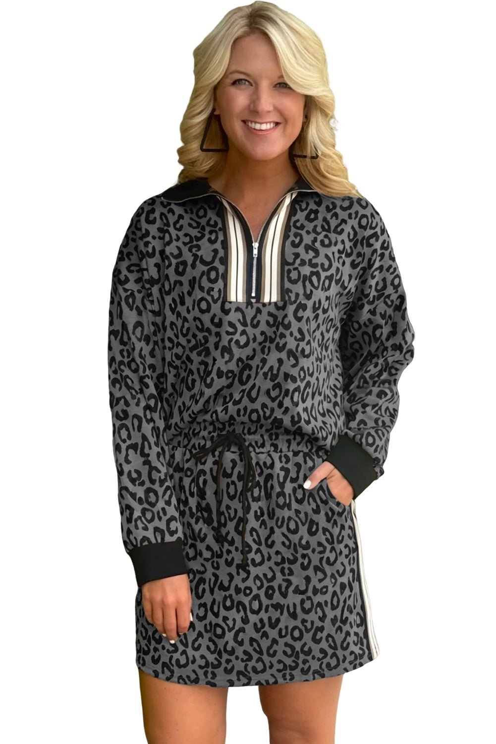 Woman wearing a leopard print dress with a silver zipper on a white background