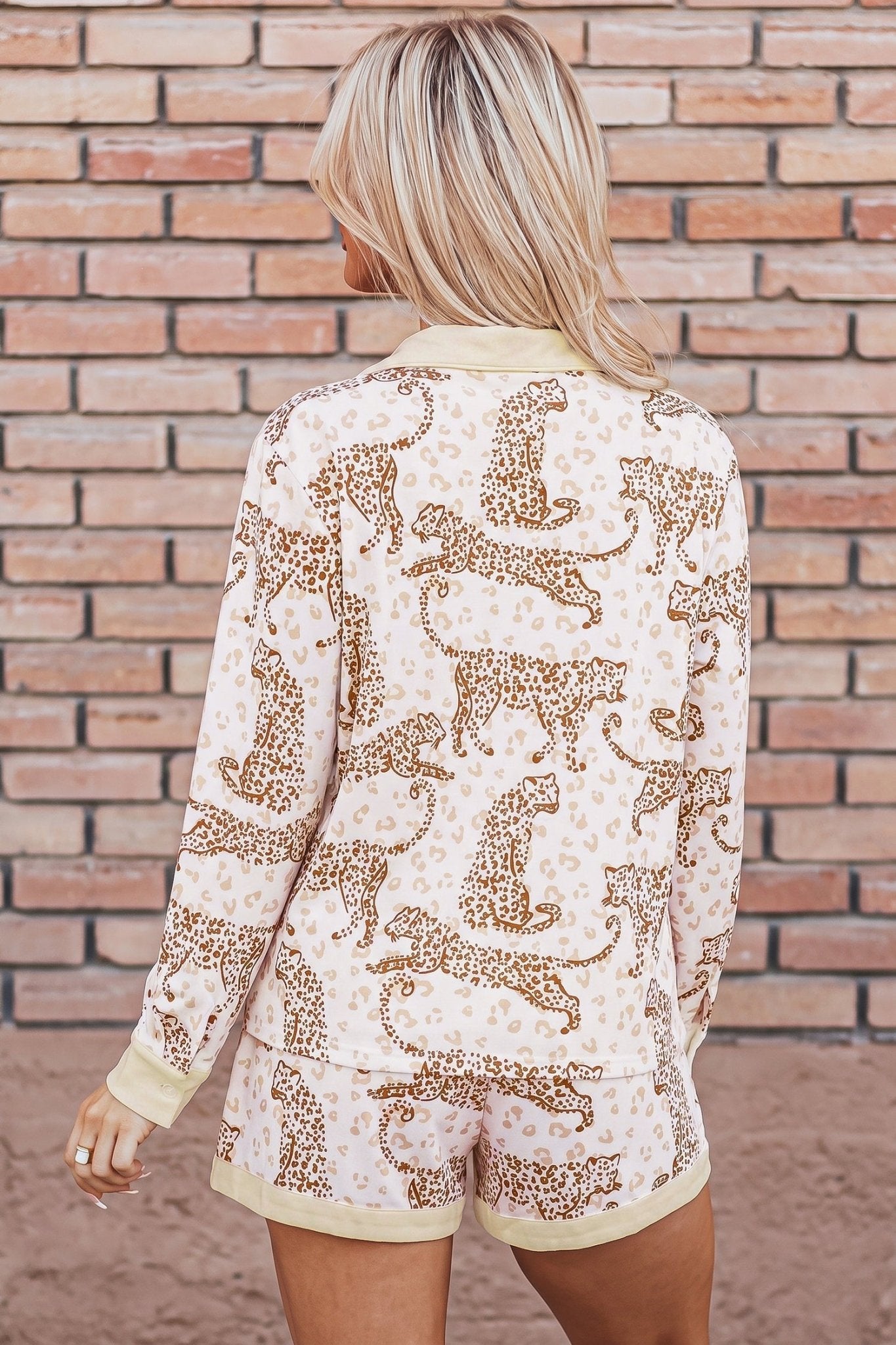 Woman viewed from behind in cream leopard-print top and matching shorts.