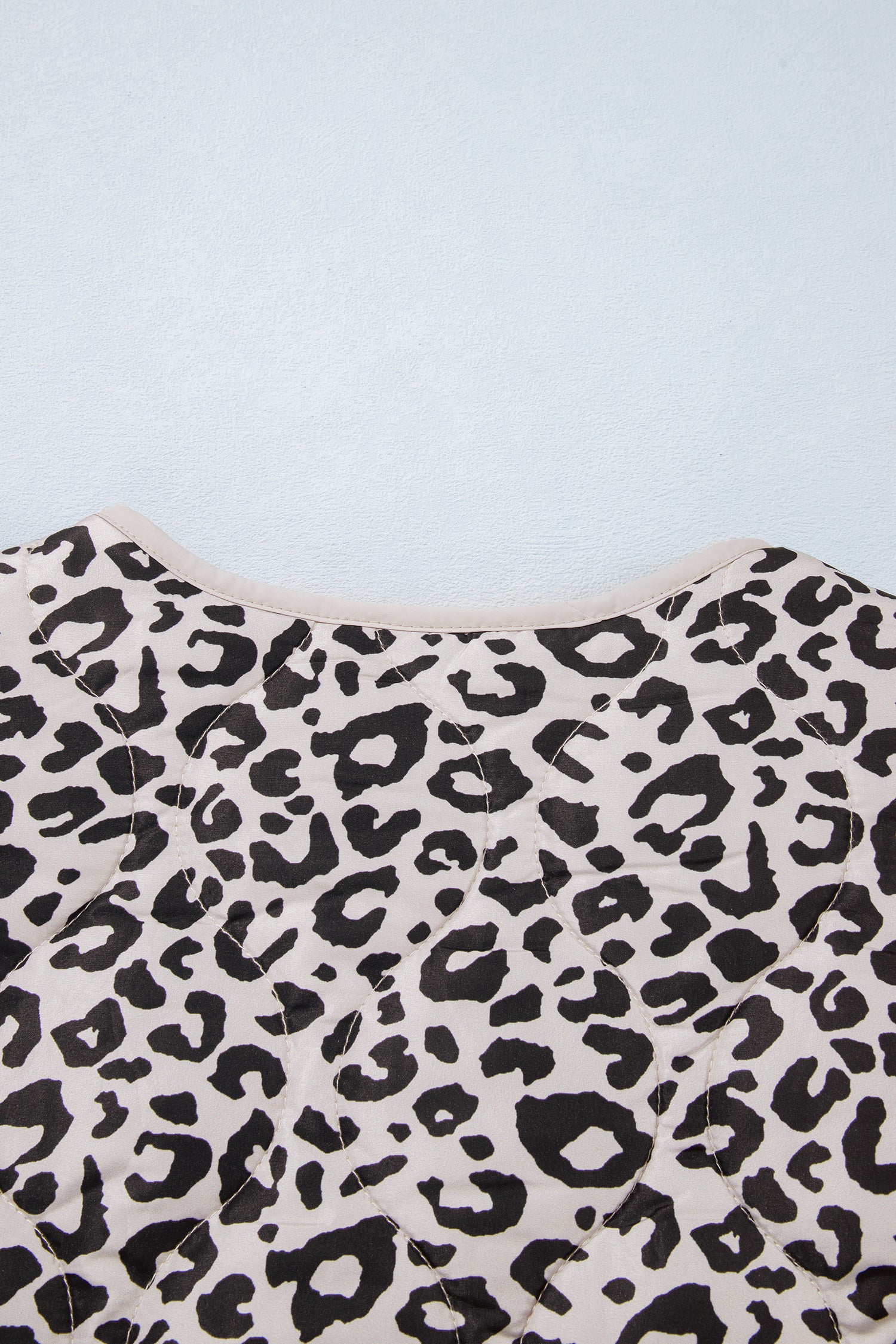 Leopard quilted jacket back neckline with cream binding trim