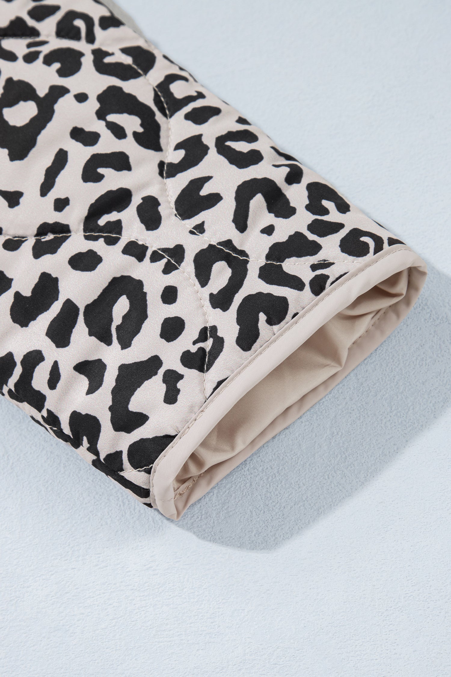 Leopard quilted jacket sleeve cuff with cream binding and lining
