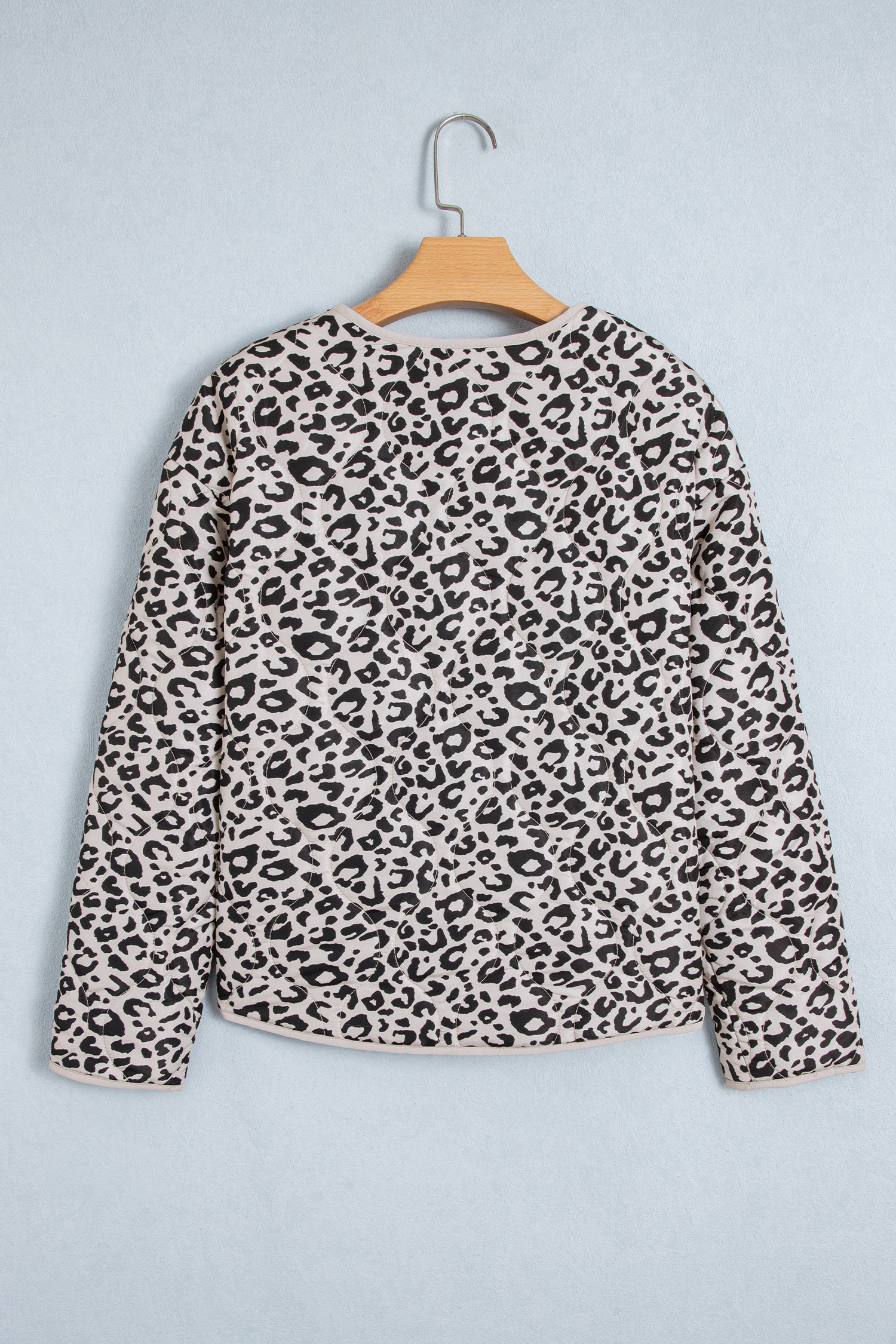 Khaki leopard print quilted jacket on a hanger, back view