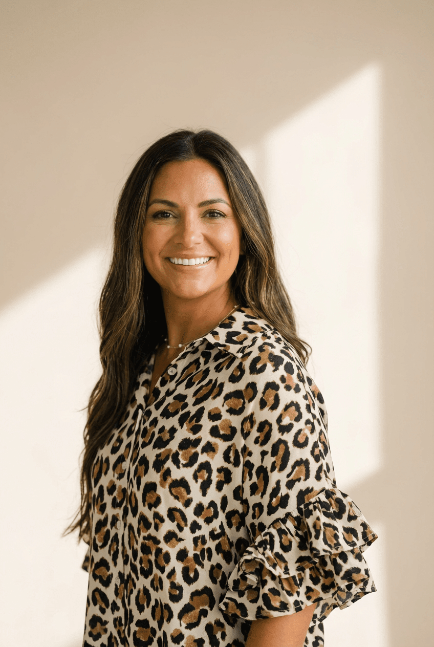 Woman wearing a leopard print blouse against a neutral background