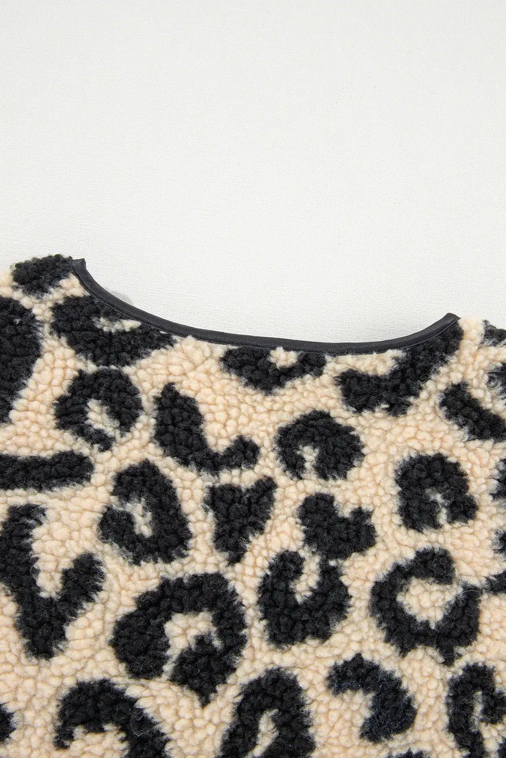 Close-up of a leopard print pattern on a textured surface.