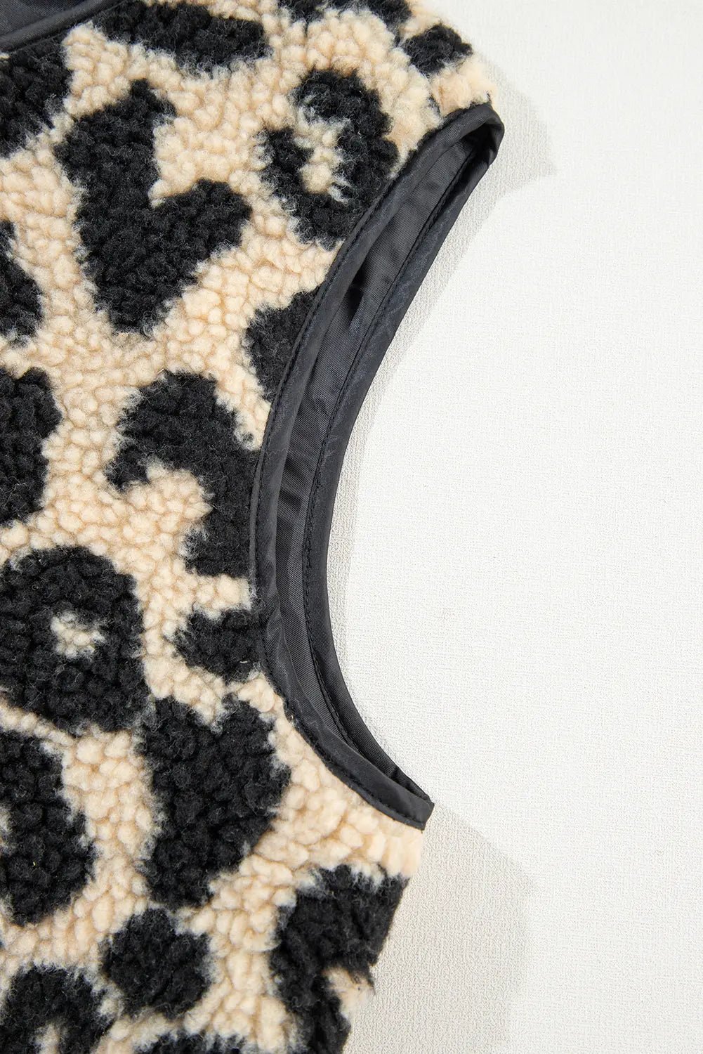 Leopard print fabric with a black elastic band on a white background