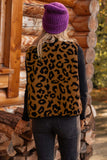 Back view of person in leopard-print fuzzy vest, black top, dark jeans, and purple beanie.