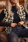 Woman in black top and dark jeans wearing a fuzzy leopard-print vest.