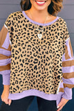 Person wearing a leopard print long-sleeve shirt with purple accents.
