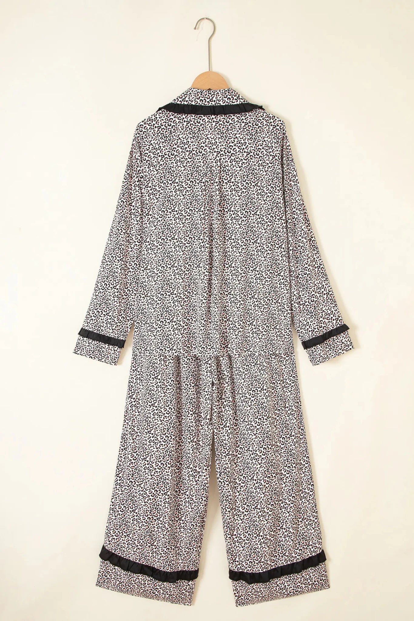 Black-and-white abstract pajama set with collared top and wide-leg pants.