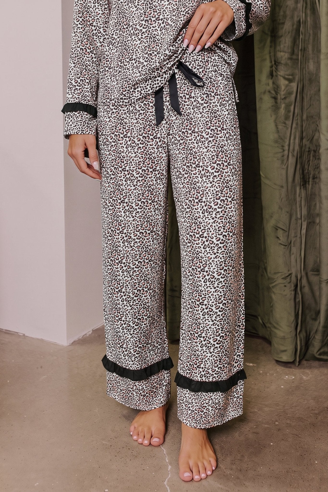 Person wearing beige, brown, and black animal-print pajamas with black trim.