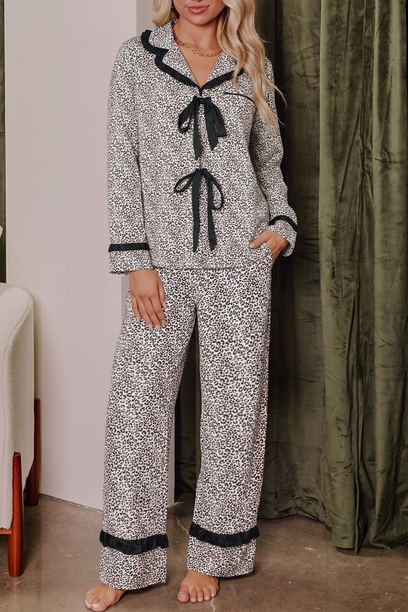 Woman wearing a black-and-white animal-print pajama set with black trim.