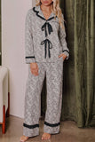 Woman wearing a black-and-white animal-print pajama set with black trim.