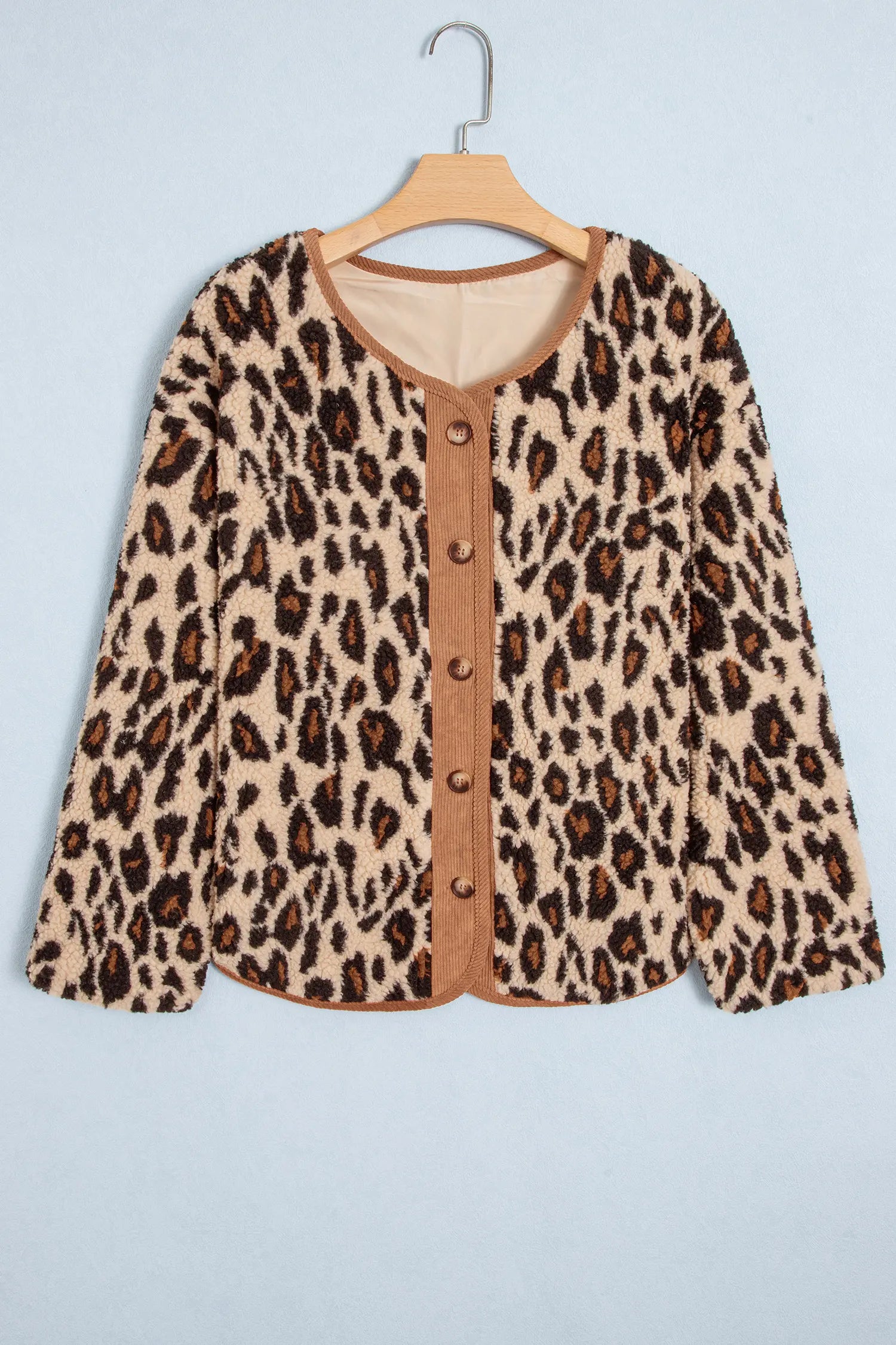 Khaki leopard sherpa jacket with corduroy button placket on a hanger, front view