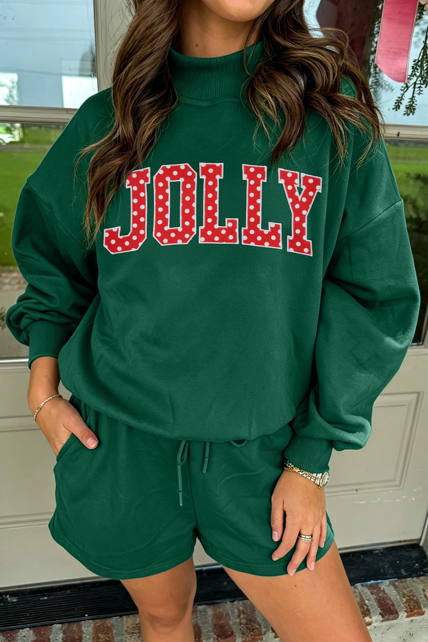 Dark green sweatshirt with red polka dot JOLLY letters and matching shorts