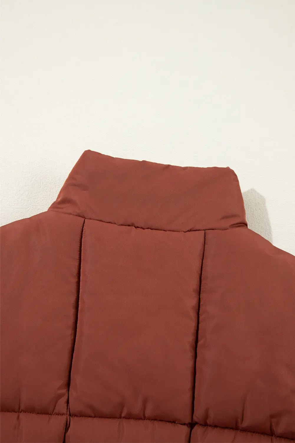 Brown puffer vest on a white background