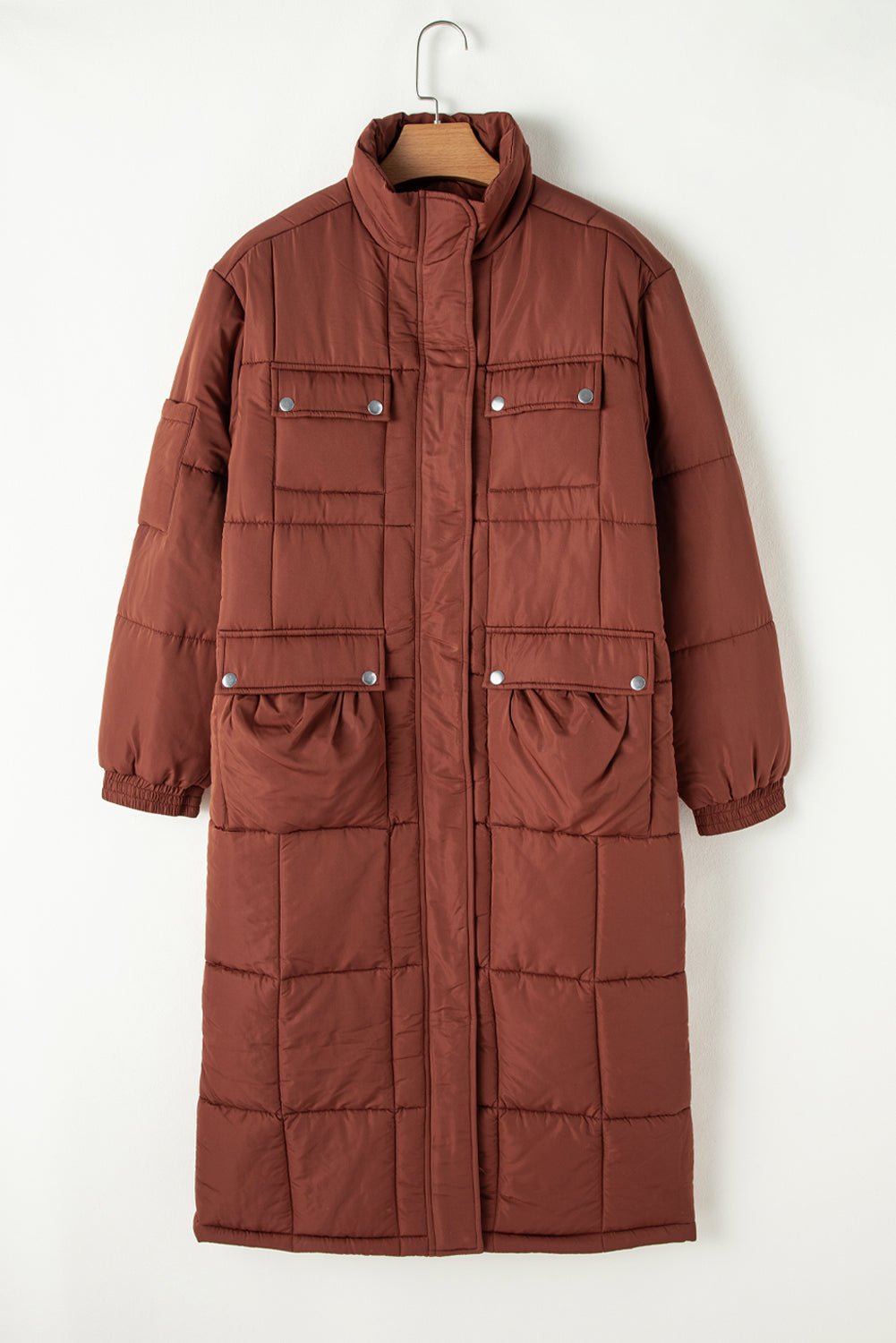 Brown puffer coat on a hanger against a white background
