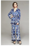 Woman wearing a blue and white patterned outfit on a gray background
