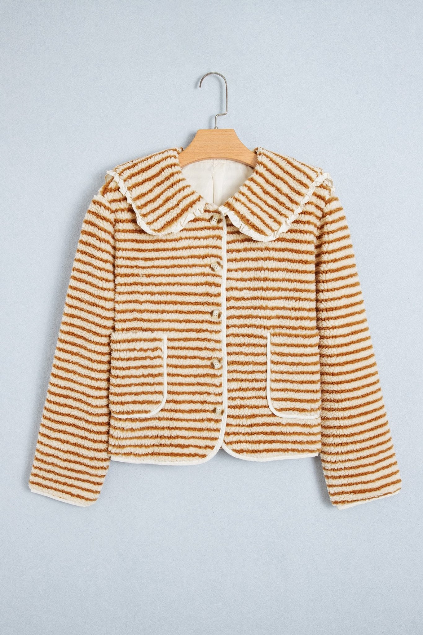 Brown-cream striped cropped jacket with rounded collar and patch pockets on hanger.