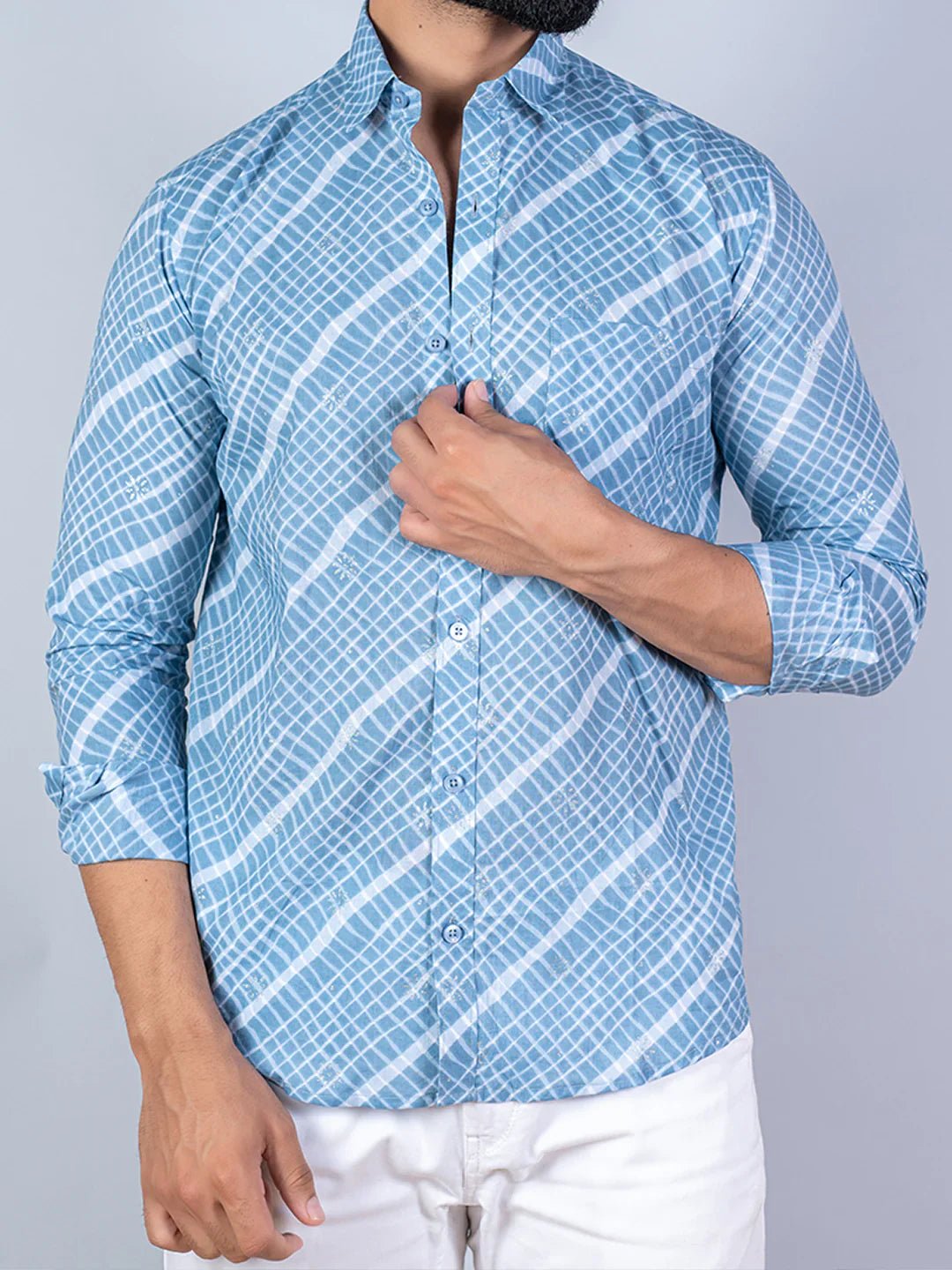 Person wearing a blue checkered shirt with white background