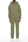 Person wearing a green tracksuit on a white background