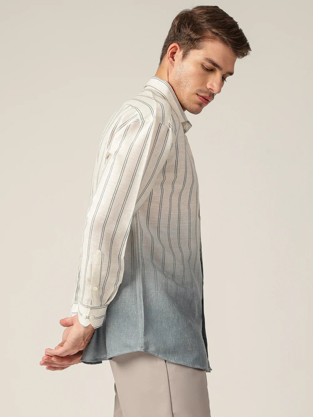 Man wearing a striped shirt with a plain background