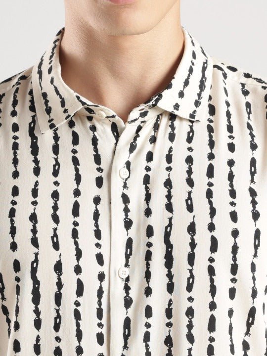 Close-up of a person wearing a black and white patterned shirt.